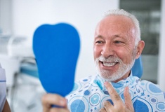 Smiling senior man checking teeth