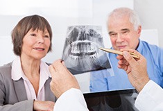 Older man and woman reviewing dental x-rays