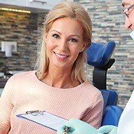 Smiling blonde woman in dental chair