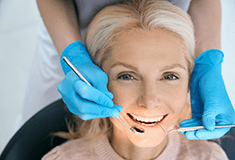 a patient smiling after replacing missing teeth