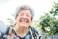 Close-up of a senior woman smiling outside