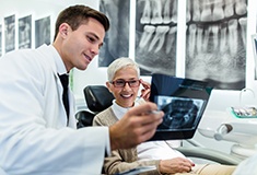 Forest emergency dentist showing patient her X-ray