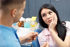 woman with toothache talking to her emergency dentist in Forest 