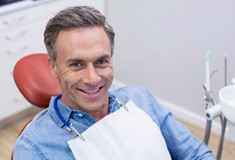 A smiling man sitting in a dentist’s chair