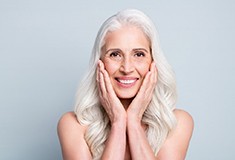 A woman enjoying her restored smile after getting implants