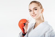 Woman holding mouthguard in Forest