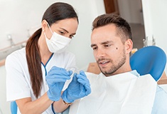 A dentist explaining the cost of Invisalign in Forest