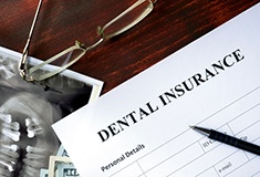 A dental insurance form marking the cost of Invisalign in Forest