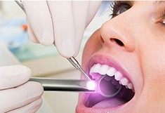 Woman receiving oral cancer screening