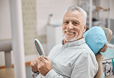 a patient smiling about the cost of root canals