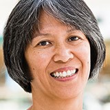 Older woman with black hair smiling