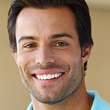 Smiling young man wearing pale blue shirt