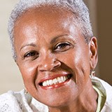 Older woman with earrings smiling