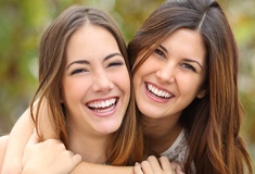 Two girls hugging and smiling