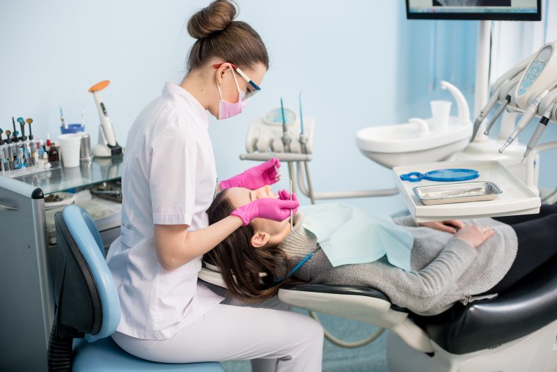Dental hygienist treating patient