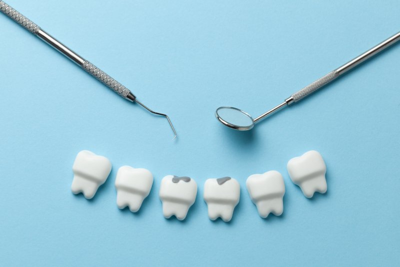 teeth with cavities and dental tools