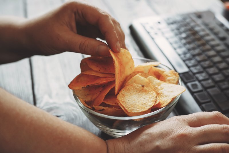 person snacking while working