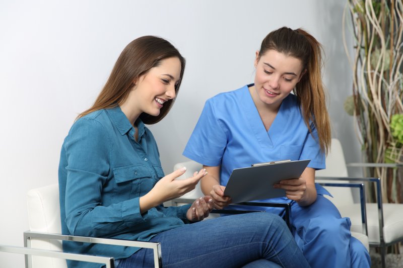 smiling patient learning about getting a root canal in Forest