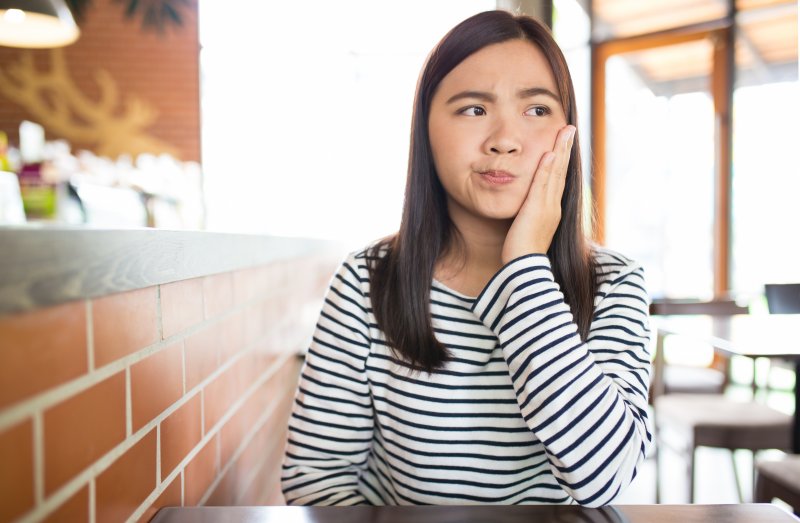 a woman experiencing discomfort after root canal therapy