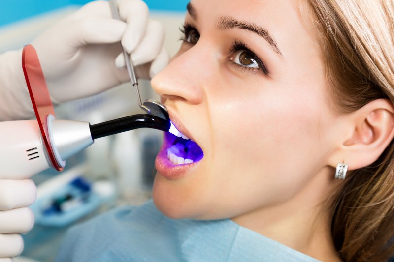 A woman getting teeth whitening treatment